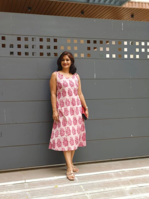 A girl in hand block printed cotton pink dress
